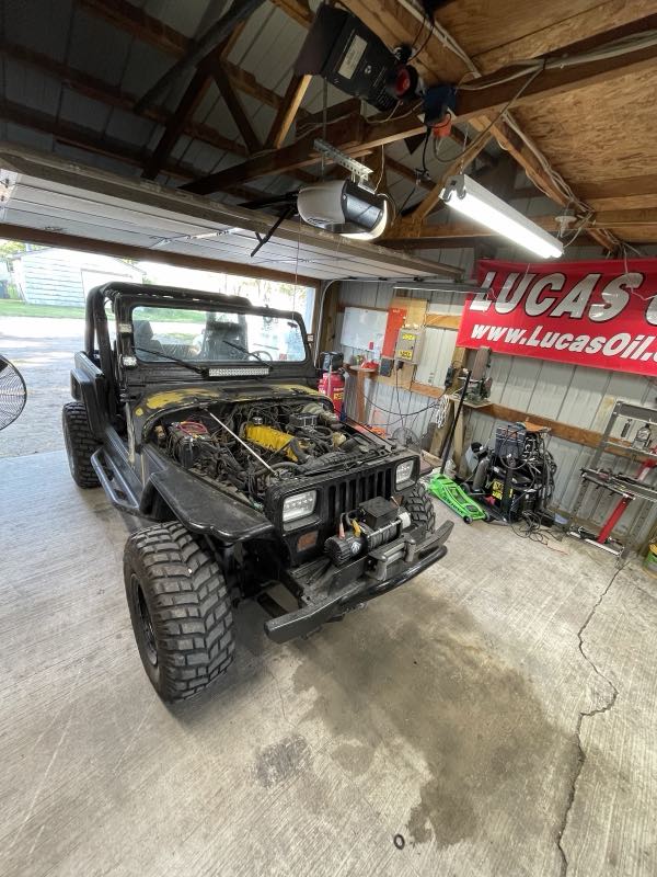 A Jeep up in the service bay for repairs